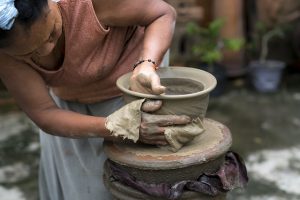 Woman Rolling Clay